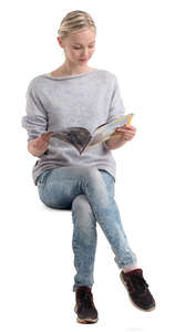 young woman sitting and reading a magazine