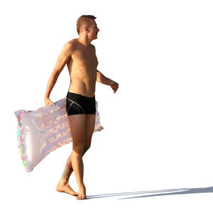 man in a bathing suit carrying a floatie 