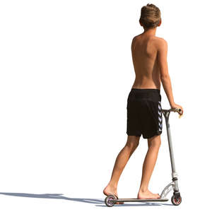 young boy in shorts riding a scooter