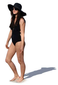 woman in a black bathing suit standing and smiling