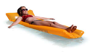 teenage girl floating on a swimming mattress