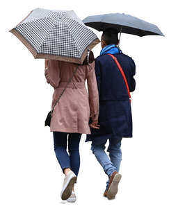 couple with umbrellas walking in the rain