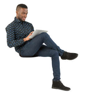 african man sitting and working with tablet