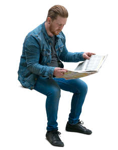 man sitting and reading a newspaper