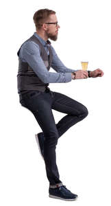 man sitting at a bar counter and drinking beer