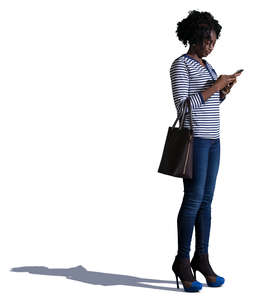 african woman standing and texting