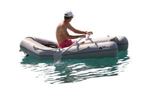 man rowing an inflatable boat