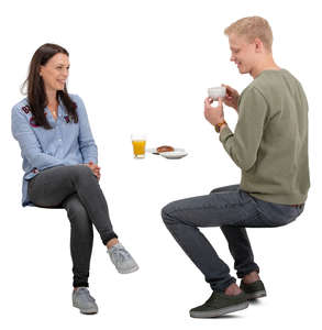 man and woman sitting and talking in a cafe
