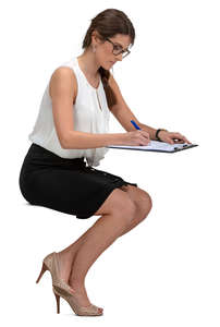 businesswoman sitting at a desk and writing