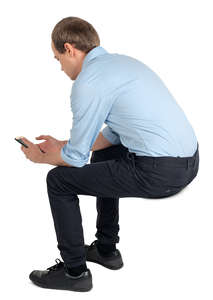 young man sitting and texting