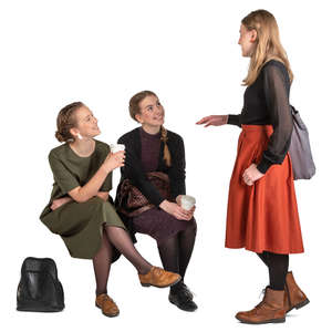 three girls sitting and talking