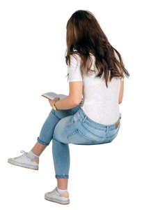 woman sitting and reading a book seen from behind