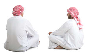 two arab men sitting on the floor and talking