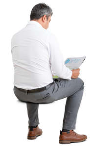 businessman sitting and reading a newspaper