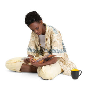 woman sitting on the floor and reading