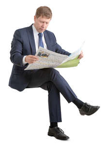 businessman in suit sitting and reading