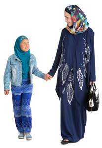 muslim woman walking with her daughter hand in hand