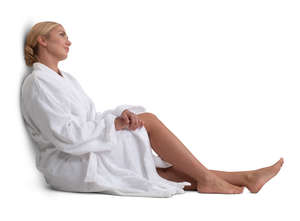 woman in a white bathrobe sitting