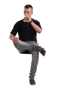 man sitting and drinking beer