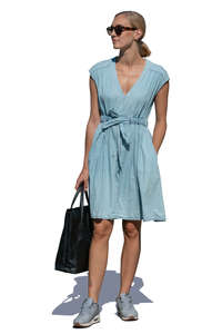 woman in a light blue summer dress standing