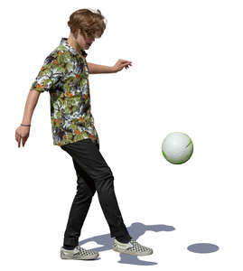 teenage boy juggling a soccer ball