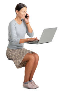 woman sitting at an office desk and working with a computer