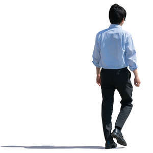 backlit asian man walking