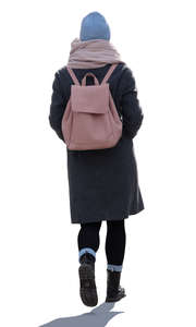 backlit woman with a pink backpack walking
