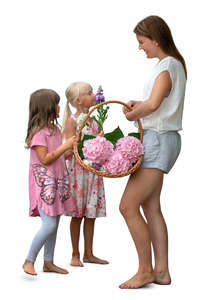 woman with two girls picking flowers