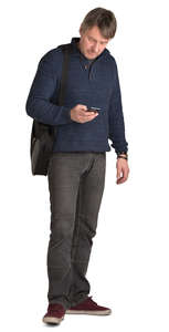 man standing and checking his phone
