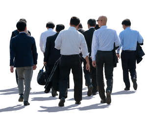 backlit group of businessmen walking