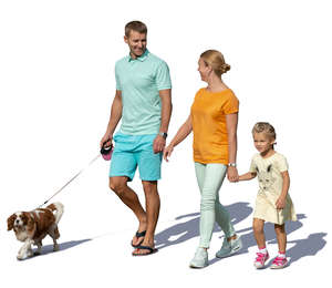 family with a dog walking hand in hand