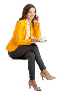 woman sitting in a cafe and talking on a phone