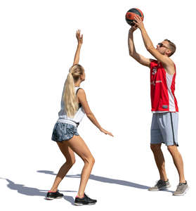 man and woman playing basketball outside