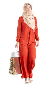 muslim woman in a red abaya shopping
