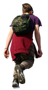 boy with a backpack walking up the stairs seen from below