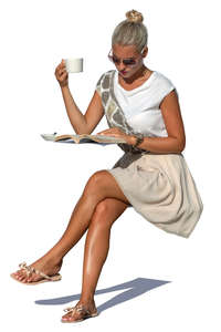 woman drinking coffee and reading a magazine