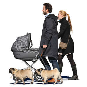 man and woman walking with a baby carriage and two dogs