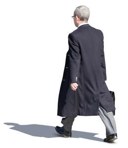 businessman in a black overcoat walking on the street