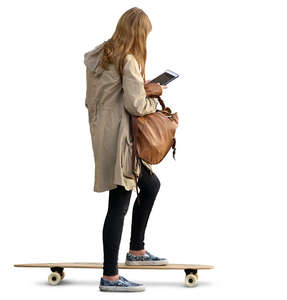 young woman standing on a skateboard and looking at ipad