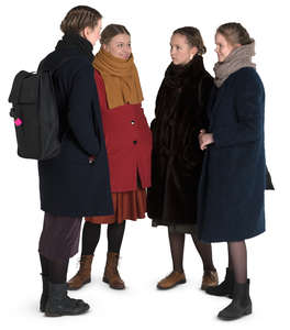 group of teenage girls standing in a circle and talking