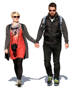couple walking hand in hand on a sunny spring day