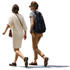 two backlit women walking side by side