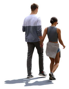 backlit couple walking hand in hand