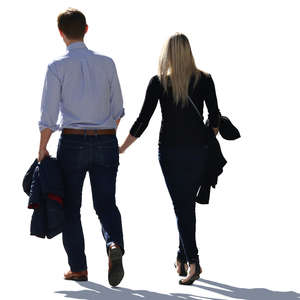 backlit couple walking hand in hand