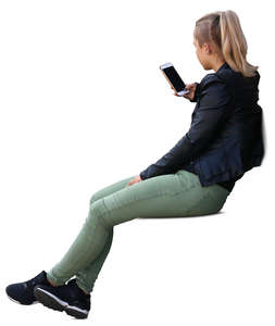 young woman sitting and looking at her phone