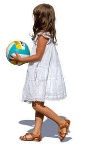 little girl with a ball walking