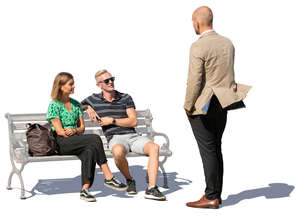 two people sitting talking with a standing man