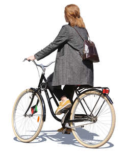 woman in a grey jacket riding a bicycle