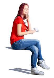 young woman sitting in a cafe and drinking coffee